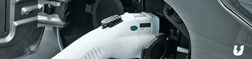 A close-up of an EV car getting charged.